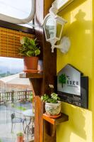 a wall with two potted plants and a window at Dream House in Pinghe