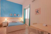 Łóżko lub łóżka w pokoju w obiekcie Approdo Rooms - Eja Sardinia