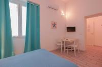 Telewizja i/lub zestaw kina domowego w obiekcie Approdo Rooms - Eja Sardinia