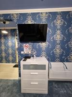 Televízia a/alebo spoločenská miestnosť v ubytovaní TILLA Apartman