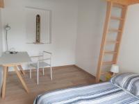 a bedroom with a bed and a desk and a ladder at Maison La Bernerie-en-Retz, 3 pièces, 6 personnes - FR-1-612-82 in La Bernerie-en-Retz