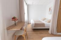 a bedroom with a desk and a bed and a table at Hôtel Porte Mars Reims Gare Centre Arena in Reims