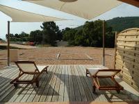 two chairs and an umbrella on a wooden deck at Residence Conca Blue in Conca