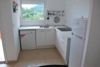 a white kitchen with a sink and a window at Residence Conca Blue in Conca