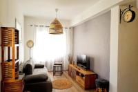 a living room with a couch and a tv at Charming T2 Equipped 1min Walk To Beaches in Toulon