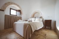 A bed or beds in a room at Trulli Difesa