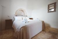 A bed or beds in a room at Trulli Difesa