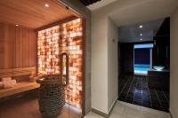 a bathroom with a shower with a brick wall at Hotel Villa Romantic &amp; Spa in Paris