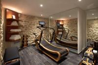 a fitness room with two exercise bikes and a mirror at Hotel Villa Romantic &amp; Spa in Paris