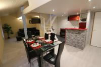 a dining room and kitchen with a table and chairs at Apparts Gites Cholet centre in Cholet