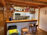 a kitchen with a counter and a sink and a counter top at Appartement cosy au pied du MtBlanc in Chamonix
