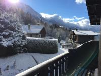 a view from a balcony of a snow covered mountain at Appartement cosy au pied du MtBlanc in Chamonix
