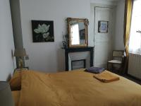 a bedroom with a bed with a mirror and a fireplace at La Bonne Etoile, près Giverny in Vernon