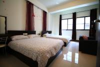 a bedroom with two beds and a window at Fu Taitung Homestay in Taitung City