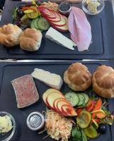 two black trays with different types of food on them at The Ilchester Arms Hotel, Ilchester Somerset in Ilchester
