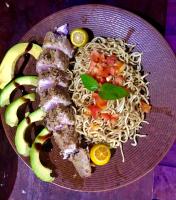 een bord met noedels, vis en fruit bij TABARI DIVE LODGE in Pulau Mansuar