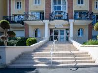a building with stairs in front of it at Apartment Port Guillaume-6 by Interhome in Cabourg