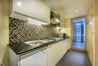 a kitchen with a sink and a counter top at Bandara Suites Silom, Bangkok in Bangkok