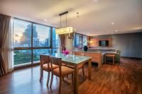 a kitchen and dining room with a table and chairs at Bandara Suites Silom, Bangkok in Bangkok