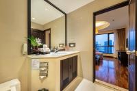 a bathroom with a sink and a mirror at Bandara Suites Silom, Bangkok in Bangkok