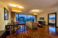 a living room with a table and a couch at Bandara Suites Silom, Bangkok in Bangkok