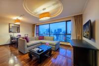 a living room with a couch and a table at Bandara Suites Silom, Bangkok in Bangkok