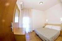 A bed or beds in a room at Residence Columbia