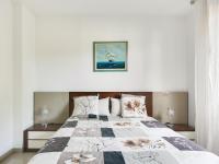 a bedroom with a bed with a quilt on it at Apartment Les Pins D&#39;Alep by Interhome in Le Cannet