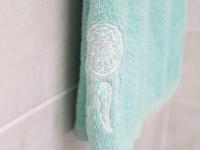 a blue towel with a white design on a wall at Manganao Loft Bord de mer in Belle-Allée