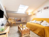 a bedroom with a yellow bed and a skylight at Apartment Berasteguia-5 by Interhome in Ciboure