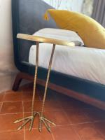 a wooden side table next to a bed at L&#39;Oiseau Bleu ROLLIER in Roubia