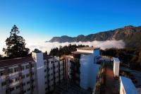 a view of a building with clouds in the mountains at Alishan Hotel in Xianglin