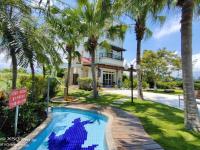 a house with a swimming pool and palm trees at Fish House 宜蘭獨棟別墅 戲水池 生態DIY 安農溪自行車 in Dongshan