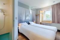 A bed or beds in a room at B&amp;B HOTEL Aix-en-Provence Pont de l&#39;Arc