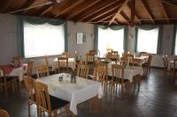 a dining room with tables and chairs and windows at Hotel &amp; Restaurant Bergfried in Saalfeld