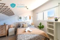 A bed or beds in a room at SkySea Holidays CITY CENTER SUITES