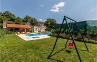a swing in a yard next to a pool at Awesome Home In Vinjani Donji With 5 Bedrooms, Wifi And Outdoor Swimming Pool in Bilopavlovići