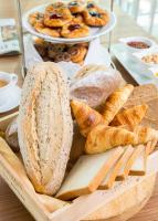 a tray of bread and pastries on a table at Eastin Grand Hotel Sathorn in Bangkok