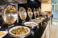 a row of plates of food on a buffet at Eastin Grand Hotel Sathorn in Bangkok