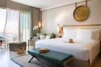 a hotel room with a bed and a large window at Jumeirah Muscat Bay Oman in Muscat