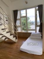 a room with a staircase and a bed and windows at I Leisure B&amp;B in Yuanshan