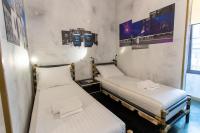 two twin beds in a room with posters on the wall at Timeout Heritage Hotel Zagreb in Zagreb
