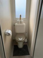 a small bathroom with a toilet with a window at Chalet Max II in Helming