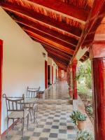 a porch with a table and chairs and a ceiling at ViaVia Leon in León
