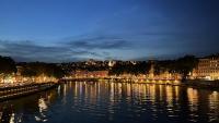 a view of a river with a city at night at Berges du Rhône&#47; Chambre avec balcon in Lyon
