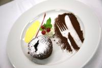 un plato blanco con un postre de chocolate encima en Hotel Miramonti Corvara, en Corvara in Badia