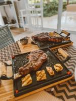 a table with two different types of meats and food at Golf Ville Resort Brisa do Golf -Apartamentos e Cobertura in Aquiraz
