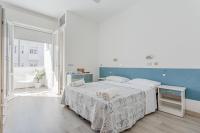 A bed or beds in a room at Hotel Lucerna