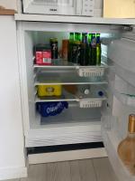 an open refrigerator filled with drinks and condiments at Lou Mut in Lectoure