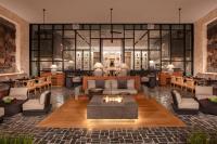 a lobby with a fireplace and tables and chairs at Impression Moxché by Secrets - Adults Only in Playa del Carmen
